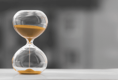 hourglass black white blurred background time is money